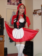 Young wife posing in little red riding hood outfit