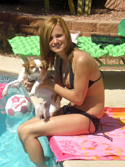 Gorgeous young babe in a tiny bikini near the pool